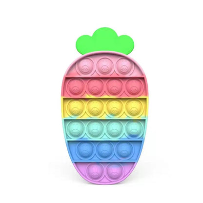 The FidgetFuns Rainbow Pop Fidget Stress Toy, shaped like a carrot with a green top, features colorful rows of pink, red, yellow, green, blue, and purple bubbles for sensory satisfaction and stress relief through endless play.