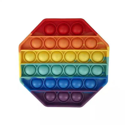 The FidgetFuns Rainbow Pop Fidget Stress Toy is an octagonal push bubble dimple with gradient colors from red to purple, offering sensory satisfaction and stress relief.