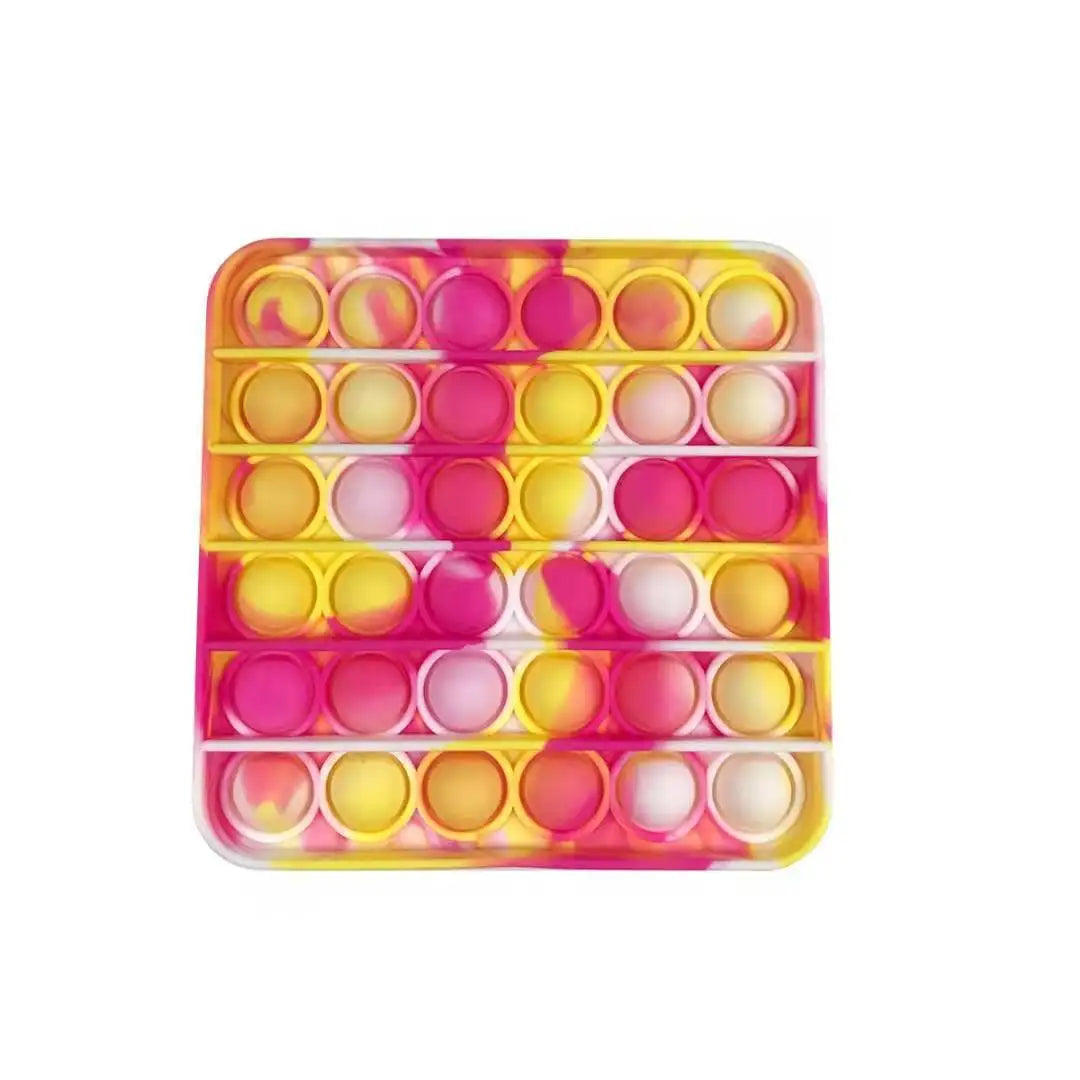 The FidgetFuns Rainbow Pop Fidget Stress Toy features a square design with a pink, yellow, and white pattern. It has 36 bubble-like dimples arranged in a grid for stress relief and sensory satisfaction as you press them.