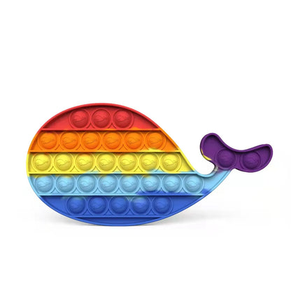 Indulge in sensory satisfaction with FidgetFuns Rainbow Pop Fidget Stress Toy – Push Bubble Dimple, shaped like a whale. Made of soft silicone, its rainbow gradient features red, orange, yellow, green, blue, and purple bubbles ideal for stress relief and fidgety fingers.